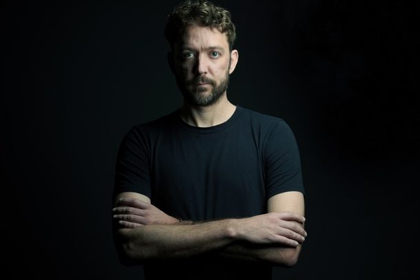 Front-End Developer Jay Bittner looking at the camera with a dark background